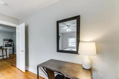 a dining room with a table and a mirror at Cincinnati Apartment 1 Mi to Hyde Park Square! in Cincinnati