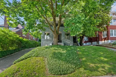 a house with a tree in the front yard at Cincinnati Apartment 1 Mi to Hyde Park Square! in Cincinnati