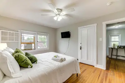 a bedroom with a white bed and a ceiling fan at Cincinnati Apartment 1 Mi to Hyde Park Square! in Cincinnati
