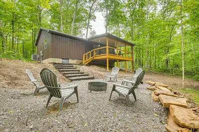 a group of chairs sitting in front of a cabin at Hike, Fish and More! Cozy Cabin in Hocking Hills in South Bloomingville