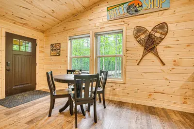 a dining room with a table and chairs in a log cabin at Hike, Fish and More! Cozy Cabin in Hocking Hills in South Bloomingville
