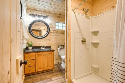 a bathroom with a toilet and a sink and a mirror at Hike, Fish and More! Cozy Cabin in Hocking Hills in South Bloomingville