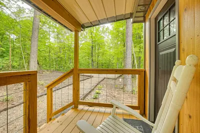 a screened in porch with two chairs and a window at Hike, Fish and More! Cozy Cabin in Hocking Hills in South Bloomingville