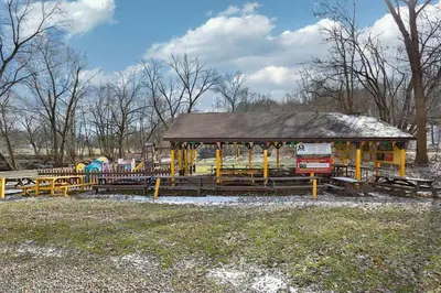 a park with a playground with benches and a pavilion at The Towpath Retreat-A Cozy Farmhouse Stay in Canal Fulton
