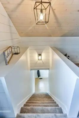 a staircase in a house with a ceiling at The Towpath Retreat-A Cozy Farmhouse Stay in Canal Fulton