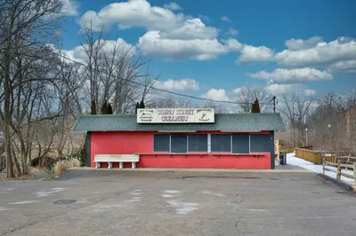 a red building with a sign on top of it at The Towpath Retreat-A Cozy Farmhouse Stay in Canal Fulton