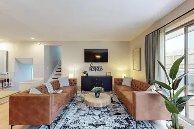 a living room with two couches and a table at Game Day Getaway-Play Relax Make Memories in Canton