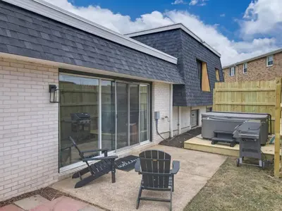 a screened in patio with a grill and a bbq grill at Game Day Getaway-Play Relax Make Memories in Canton