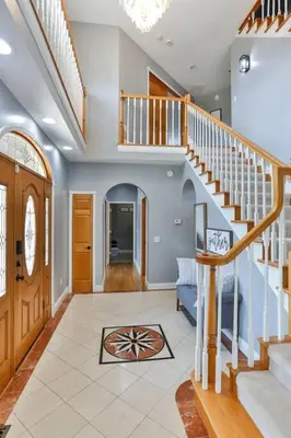 a living room with a staircase and a stair case at Hidden Acres Escape-A Bluegrass Retreat in Blaine