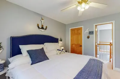 a bedroom with a large white bed with a blue headboard at Hidden Acres Escape-A Bluegrass Retreat in Blaine