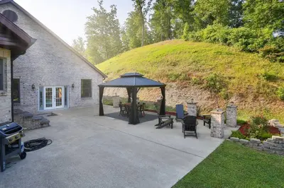 a patio with a gazebo next to a hill at Hidden Acres Escape-A Bluegrass Retreat in Blaine