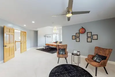 a living room with two chairs and a ceiling fan at Hidden Acres Escape-A Bluegrass Retreat in Blaine