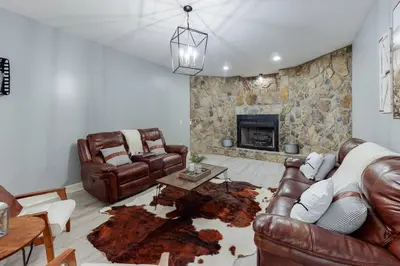 a living room with leather furniture and a fireplace at Hidden Acres Escape-A Bluegrass Retreat in Blaine