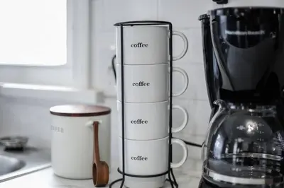 a kitchen counter with three cups and a blender at Touchdown Bungalow-Charming HOF Village Home in Canton