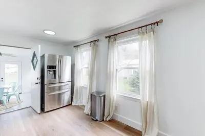 a kitchen with a stainless steel refrigerator and a window at The Huddle House-HOF Home Made for Families in Canton