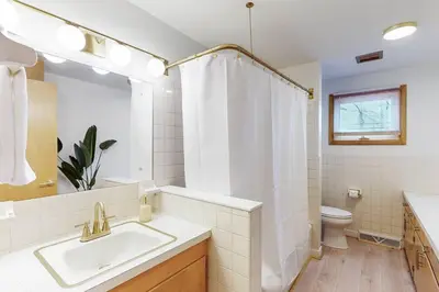a white bathroom with a sink and a toilet at Gridiron Getaway-Where Families and Fans Unite in Canton