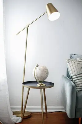 a lamp sitting on a table next to a couch at End Zone Escape-Light and Bright HOF Village Home in Canton