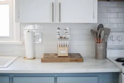a kitchen counter with a cutting board and utensils at End Zone Escape-Light and Bright HOF Village Home in Canton