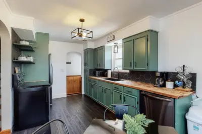 a kitchen with green cabinets and a black refrigerator at Home Champions-HOF Village Comfort in Canton