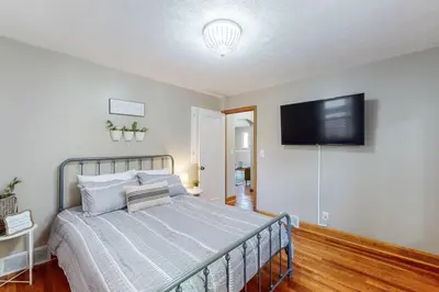 a bedroom with a bed and a flat screen tv at Home Champions-HOF Village Comfort in Canton