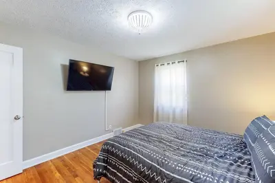 a bedroom with a bed and a flat screen tv at Home Champions-HOF Village Comfort in Canton
