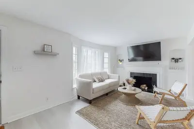 a living room with a couch and a fireplace at The Perfect Pass-HOF Village Escape in Canton