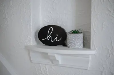 a black and white clock on a shelf with a plant at The Perfect Pass-HOF Village Escape in Canton