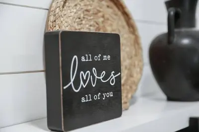 a sign that says all of me loves all of you next to an apple at Eternal Romance-The Honeymoon Suite at 1885 Farms in Navarre