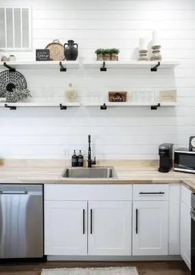 a kitchen with white cabinets and a sink at Eternal Romance-The Honeymoon Suite at 1885 Farms in Navarre