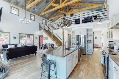 a large kitchen and living room with a staircase at Some Kind of Wonderful-Escape Near Seneca Lake in Senecaville