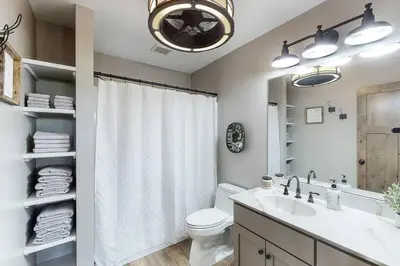 a bathroom with a sink and a toilet and a mirror at Some Kind of Wonderful-Escape Near Seneca Lake in Senecaville