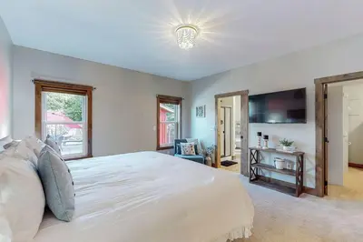 a bedroom with a large white bed and a television at Some Kind of Wonderful-Escape Near Seneca Lake in Senecaville