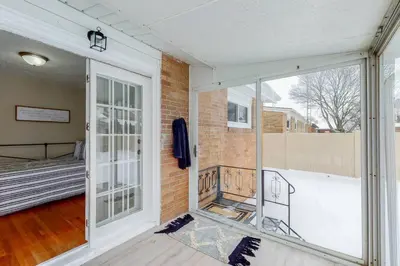 a room with a balcony with a bed and a window at Steps to the HOF-Football Fans Dream Stay in Canton