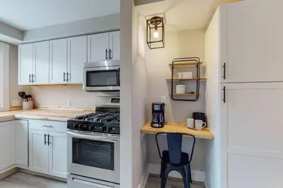 a kitchen with white cabinets and a stove top oven at Steps to the HOF-Football Fans Dream Stay in Canton