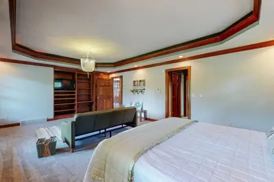 a bedroom with a large bed in a room at Grace and Grandeur-The Stables Estate in North Lawrence