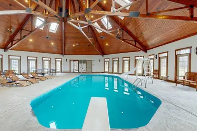 a large indoor swimming pool with a large ceiling at Grace and Grandeur-The Stables Estate in North Lawrence