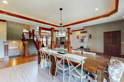 a dining room and living room with a table and chairs at Grace and Grandeur-The Stables Estate in North Lawrence