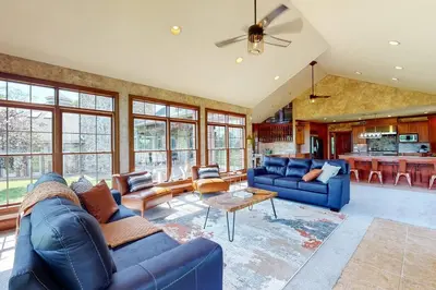 a large living room with blue couches and a table at Grace and Grandeur-The Stables Estate in North Lawrence