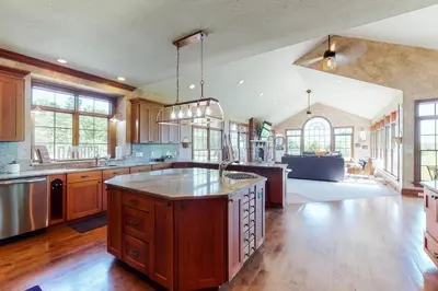 a large kitchen with a large island in the middle at Grace and Grandeur-The Stables Estate in North Lawrence