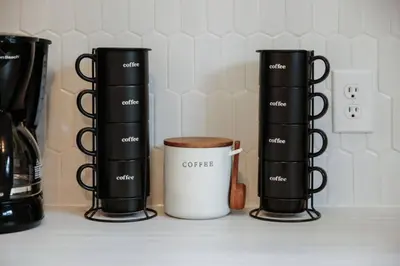 a group of three coffee cups on a counter at The Playmakers Funhouse-HOF Village in Canton