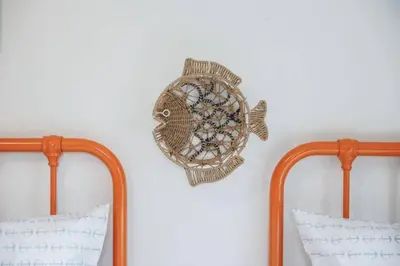 a fish decoration on a wall next to two mirrors at The Playmakers Funhouse-HOF Village in Canton