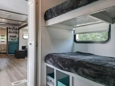 an interior of an rv with a bunk bed in it at Wildflower Wanderlust-Glamping st 1885 Farms in Navarre