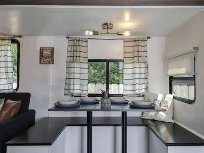 a kitchen with a table with blue dishes on it at Wildflower Wanderlust-Glamping st 1885 Farms in Navarre