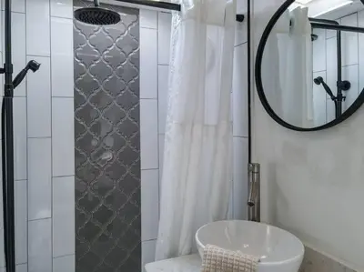 a bathroom with a sink and a shower with a mirror at Wildflower Wanderlust-Glamping st 1885 Farms in Navarre