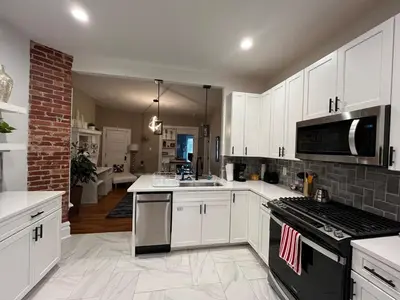 a kitchen with white cabinets and a stove top oven at 2 BR Totally Renovated and Chic in Columbus