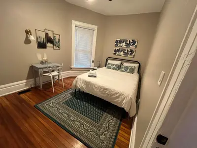 a bedroom with a bed and a table in it at 2 BR Totally Renovated and Chic in Columbus