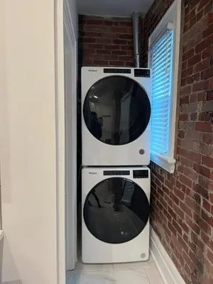 two microwaves sitting next to a brick wall at 2 BR Totally Renovated and Chic in Columbus