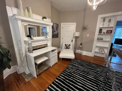 a bathroom with a white vanity and a black and white rug at 2 BR Totally Renovated and Chic in Columbus