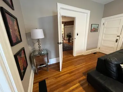 a living room with a couch and a table with a lamp at 2 BR Totally Renovated and Chic in Columbus