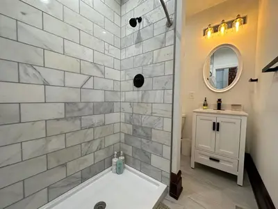 a bathroom with a tub and a sink at Big Brick 2 Bedroom apartment in Victorian Village in Columbus